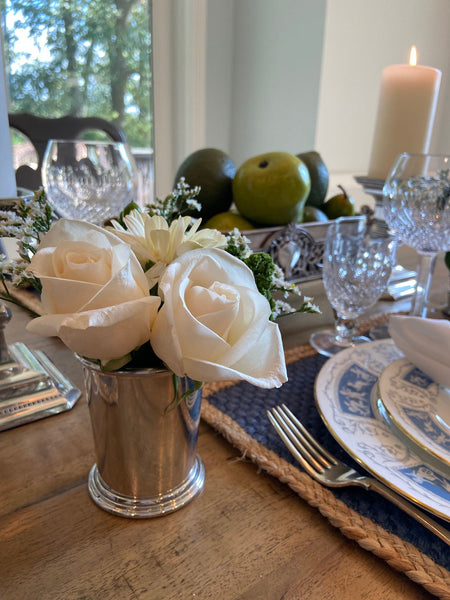 beautiful table setting with flowers in a mint julep cup being used as a vase