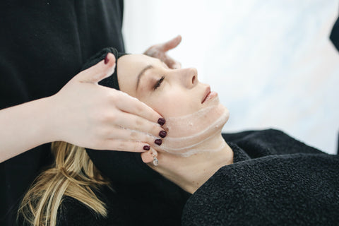woman lying down getting a facial 