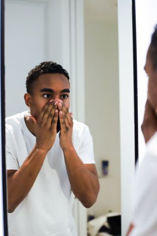 man washing face