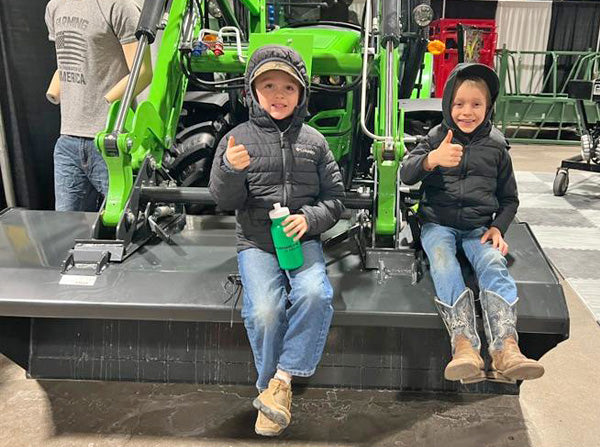 2 boys sitting on tractor at Ft. Wayne Farm Show