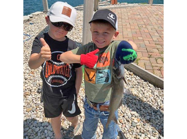 2 boys holding up a fish