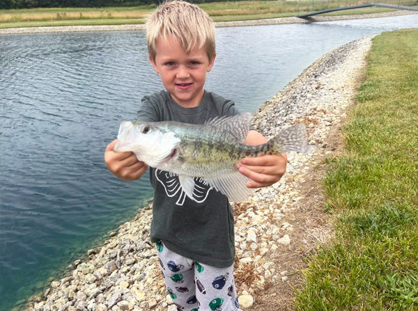 boy holding a fish