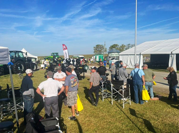 people visiting Fennig Equipment's Farm Science Review booth