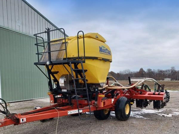 side view of 8 row Krause Gladiator strip till rig with 6 ton Montag cart