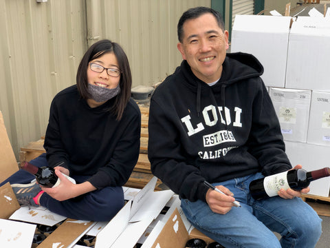 Jason and Kate Mikami hand numbering bottles of Zinfandel