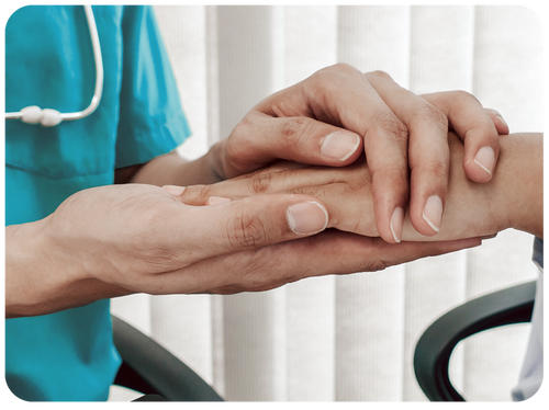 nurse holding the hand of a patient