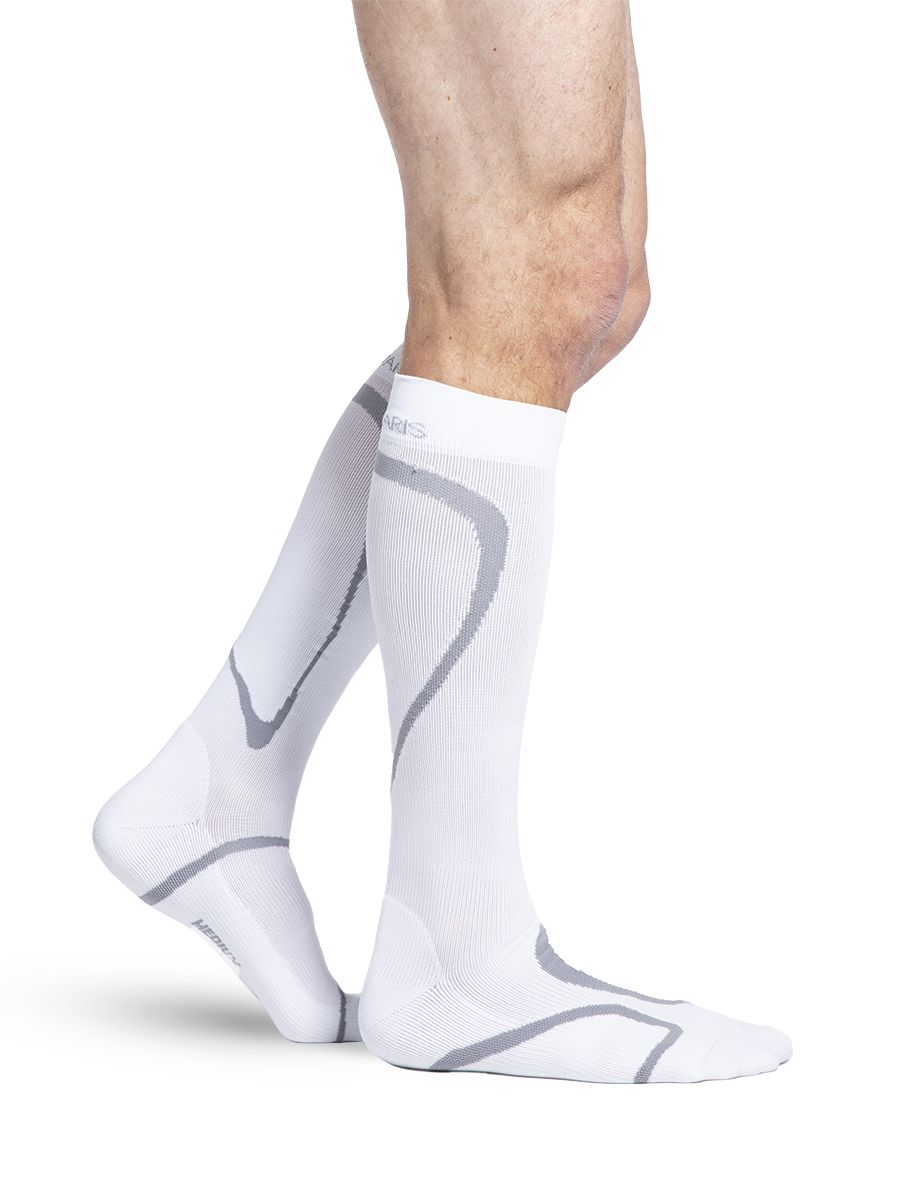 Man wearing Sigvaris Motion High Tech compression socks in the color White