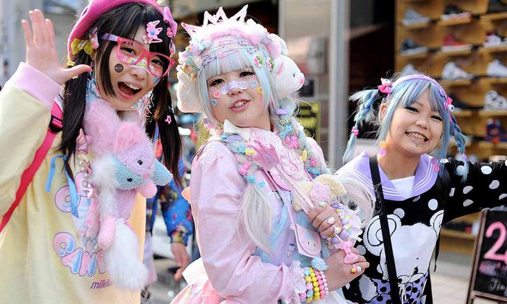 Three Japanese girls are wearing a Kawaii accessory. They have stuffed animals, kawaii Hair accessories, and they wear quilts and kawaii jewelry