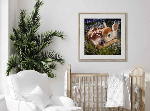 Nursery with white chair, framed fawn picture