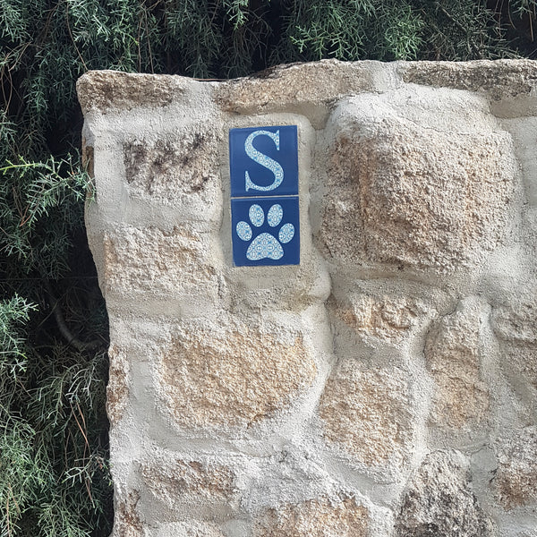 letter and pawprint tiles outside a Mediterranean villa