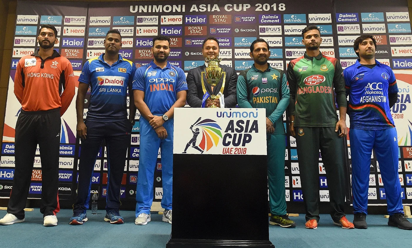 The captains around the Asia Cup trophy