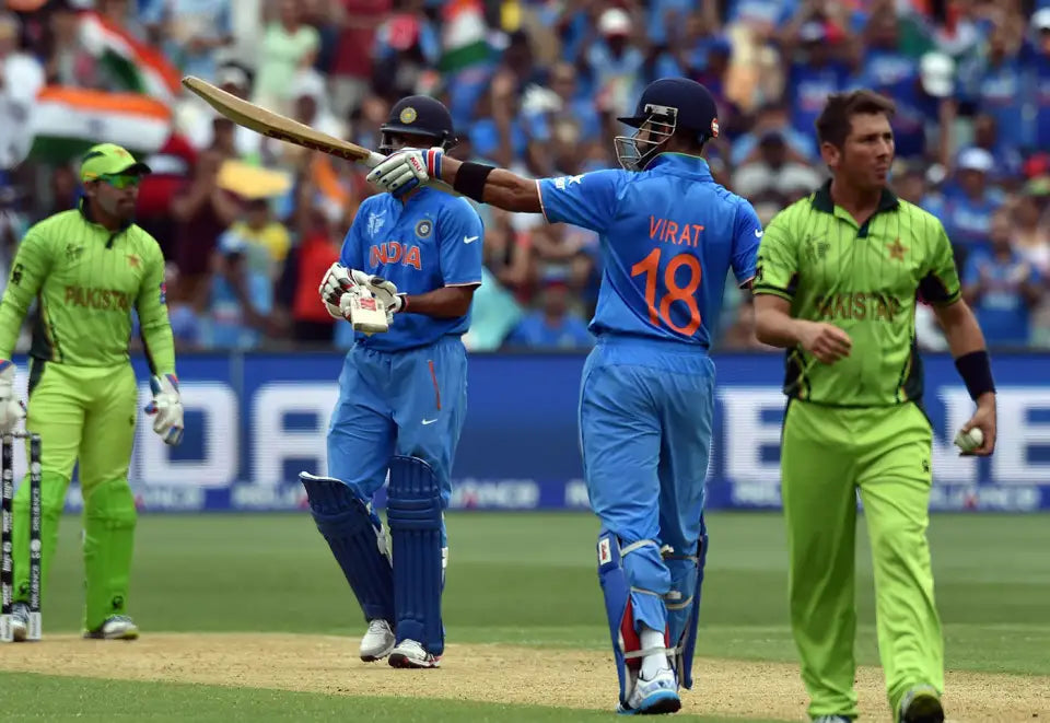 Virat Kohli Raises his bat to celebrate his century in the 2015 India vs Pakistan Cricket World Cup Match