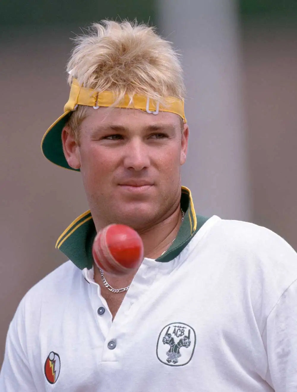 Photo of a young Shane Warne with a red leather ball