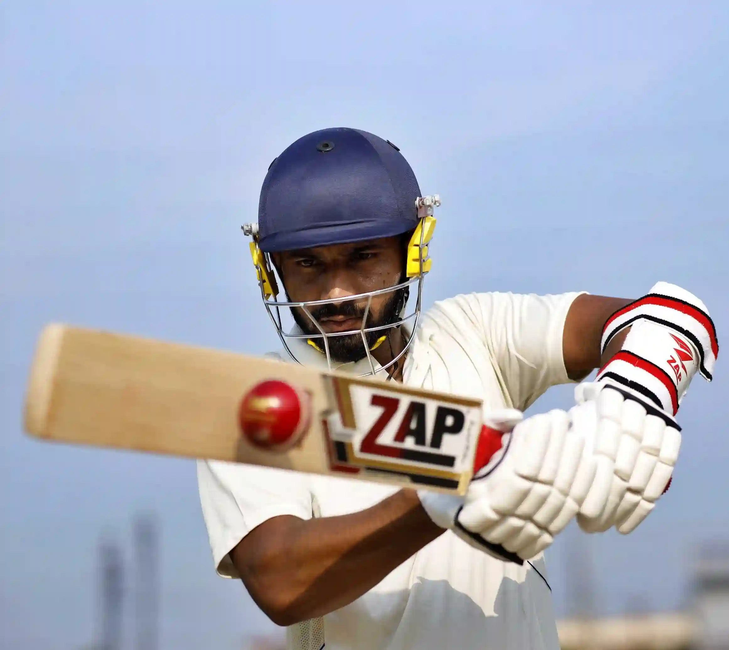 A player plays a pull shot with a ZAP Cricket Bat and Goves in hand