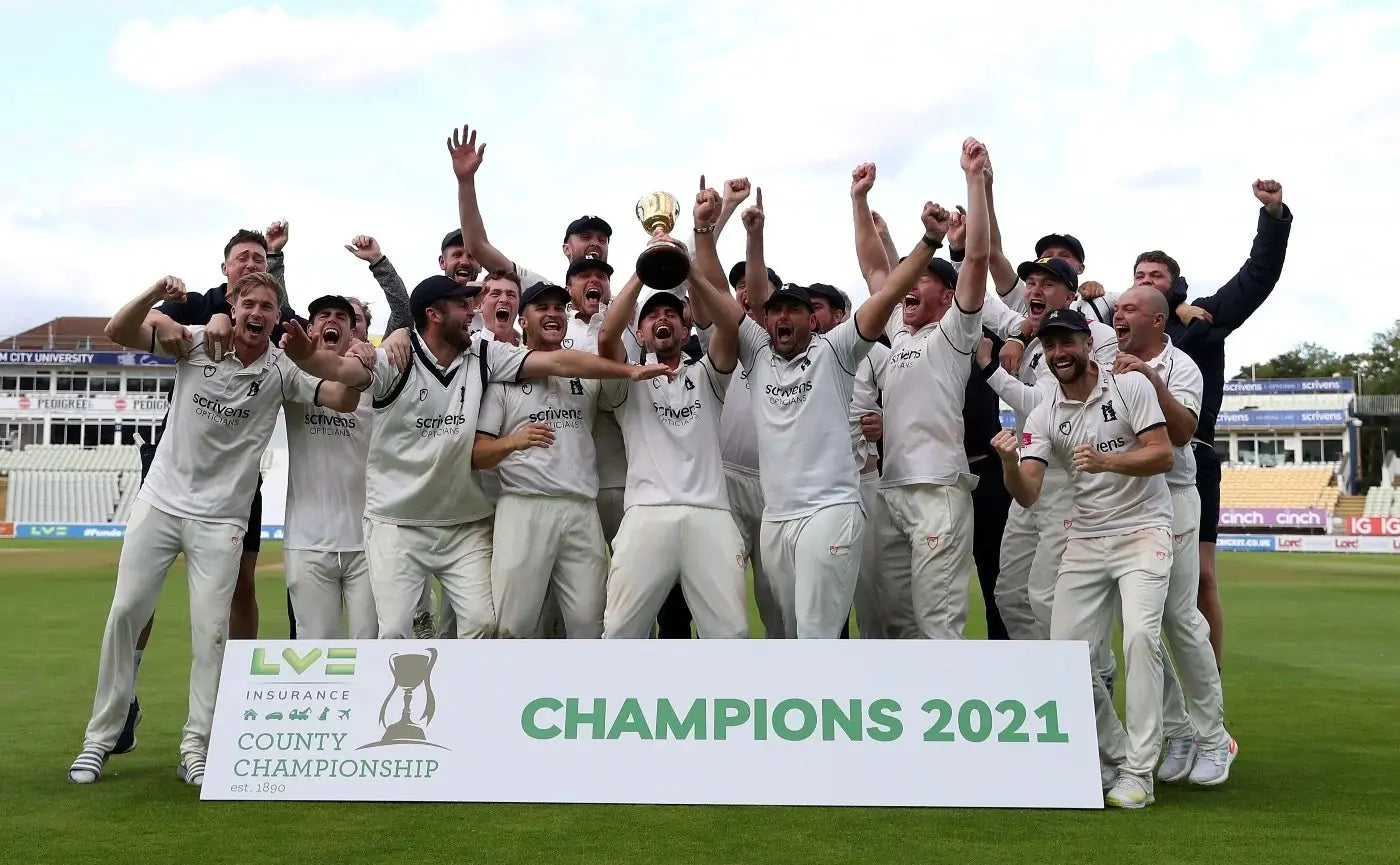 The County Cricket Championship winners of 2021 celebrate with the trophy