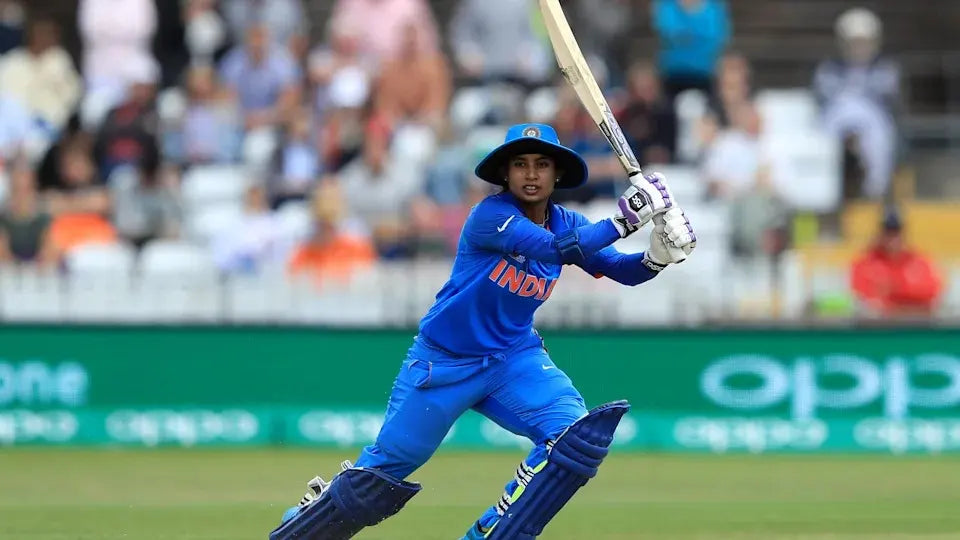 Mithali Raj watches the ball after she drive it through the off side