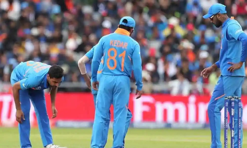 Bhuvaneshwar Kumar tries to stretch his hamstring to feel comfort before bowling