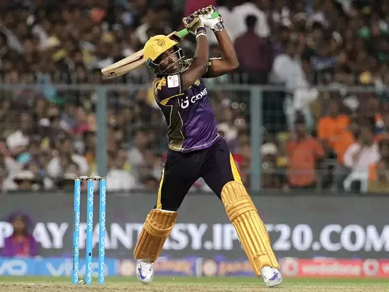 Andre Russel hits the ball out of the park for KKR in an IPL game