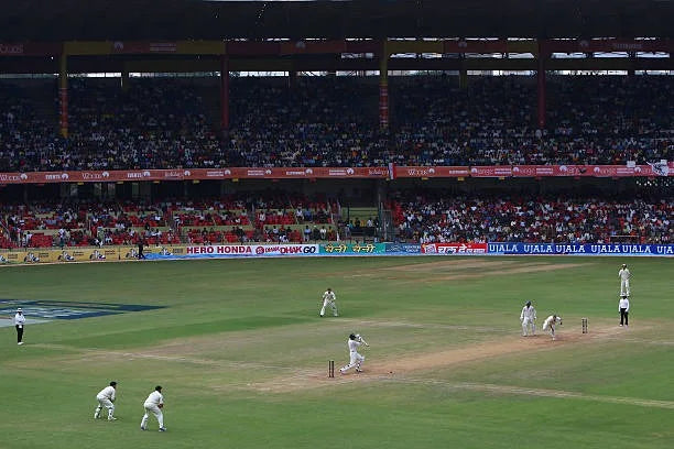A test match being played at the Chinnaswamy Cricket Ground