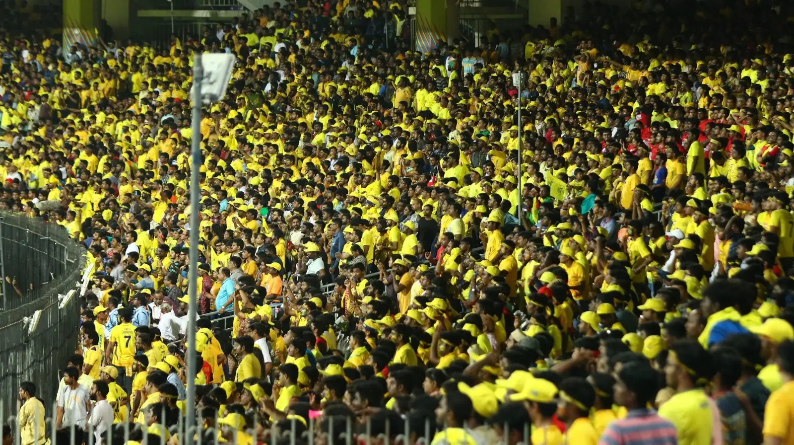 The stadium stands have turned yellow with fans wearing the yellow CSK jersey