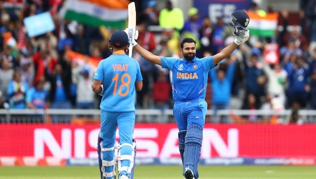 Rohit Sharma raises his bat to celebrate his hundred in the ICC 2019 World Cup with Virat Kohli applauding him