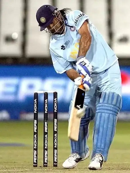 MS Dhoni hits the ball while playing the helicopter shot in cricket