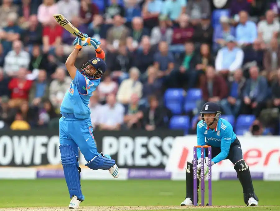 Suresh Raina steps out of the crease to play the lofted straight drive and hit the ball for a six