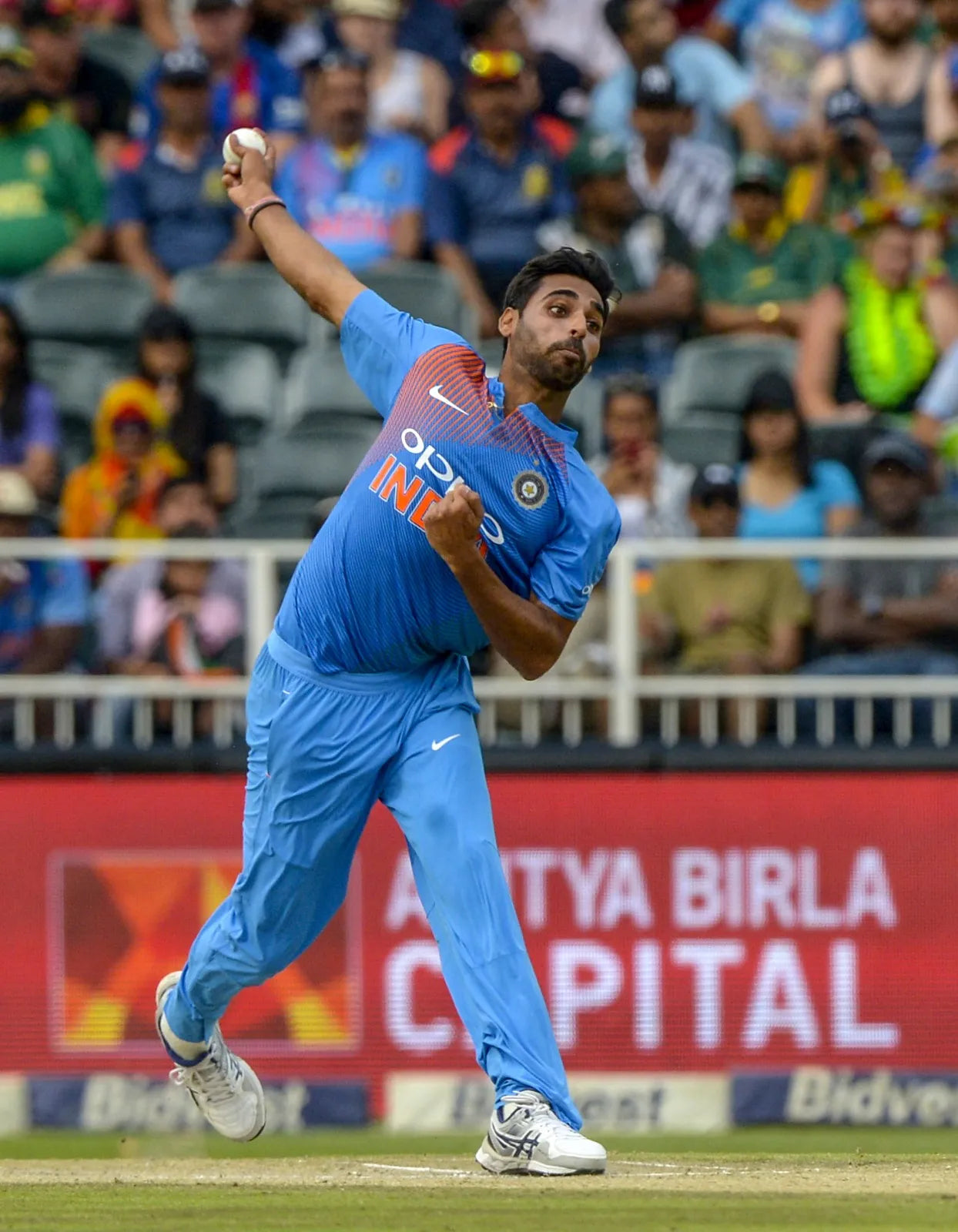 Bhuvaneshwar Kumar does his bowling action and bowls a swinging delivery
