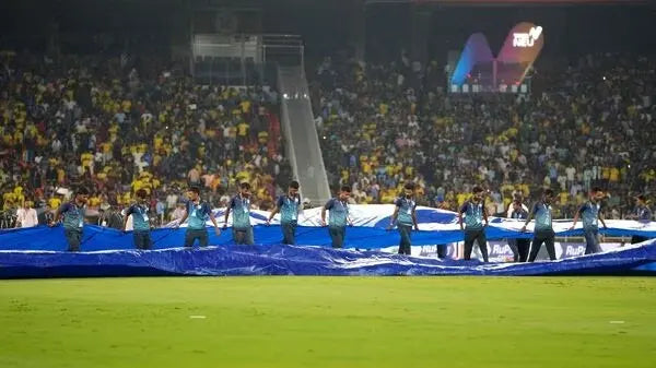 The Groundsmen drag the covers onto the ground in the 2023 IPL Final Between CSK and GT