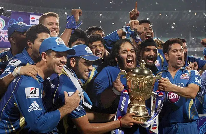 The 2013 Mumbai Indians IPL Team celebrating with the IPL Trophy