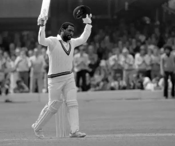 Sir Viv Richards raises his bat to celebrate a century