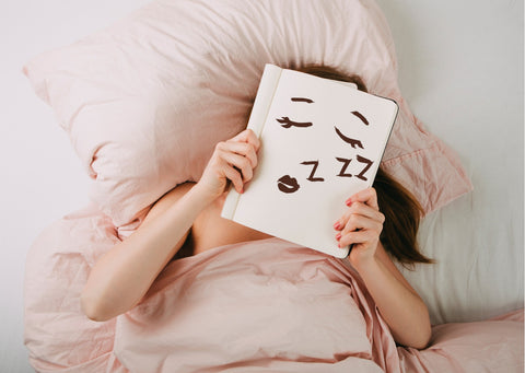 bed time routine lady in bed reading a book