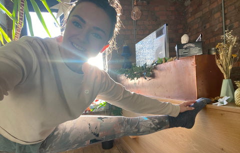 lady performing yoga stretch in yoga studio