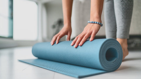 woman preparing yoga mat for exercise