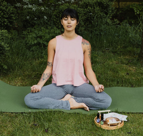 Woman Performing Yoga Meditation on Grass Outside