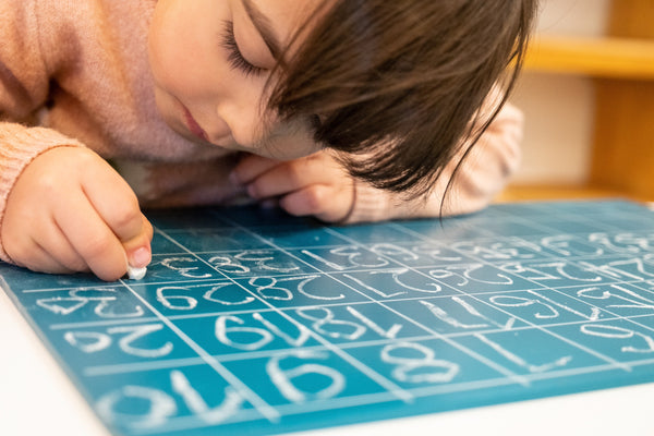 Young girl writing on the alphabet