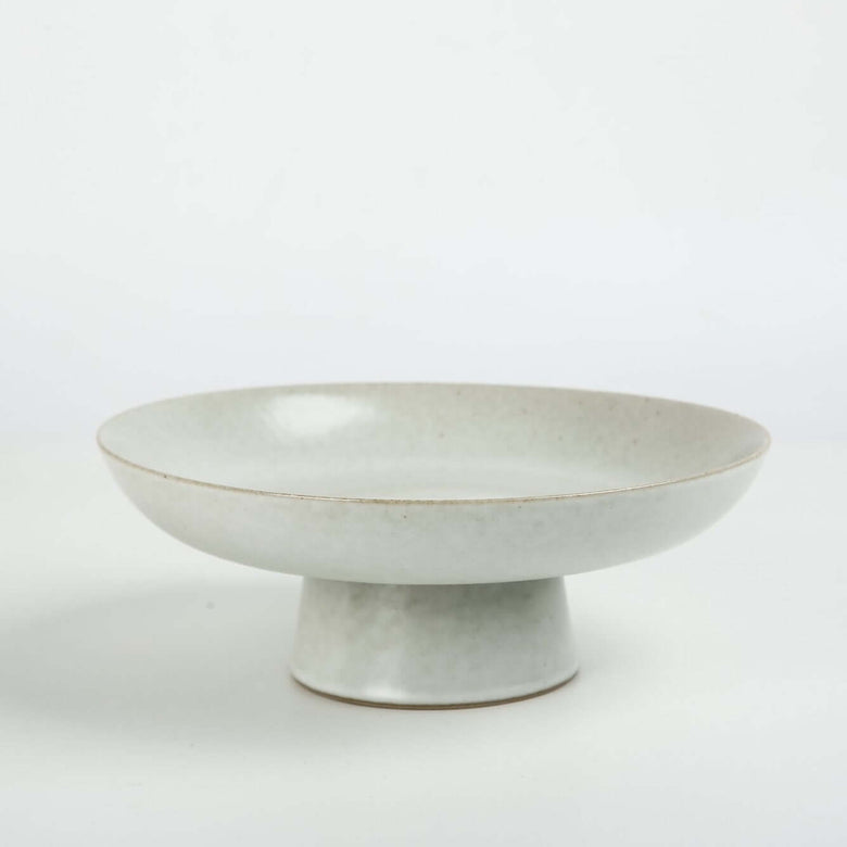 white ceramic pedestal fruit bowl