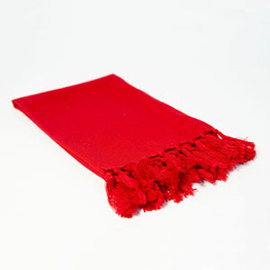 Reusable bright red cloth napkin handwoven by Guatemalan artisans out of 100% cotton with a fringe along one edge