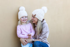 mum and daughter wearing matching pom pom winter beanies, cubs and co 