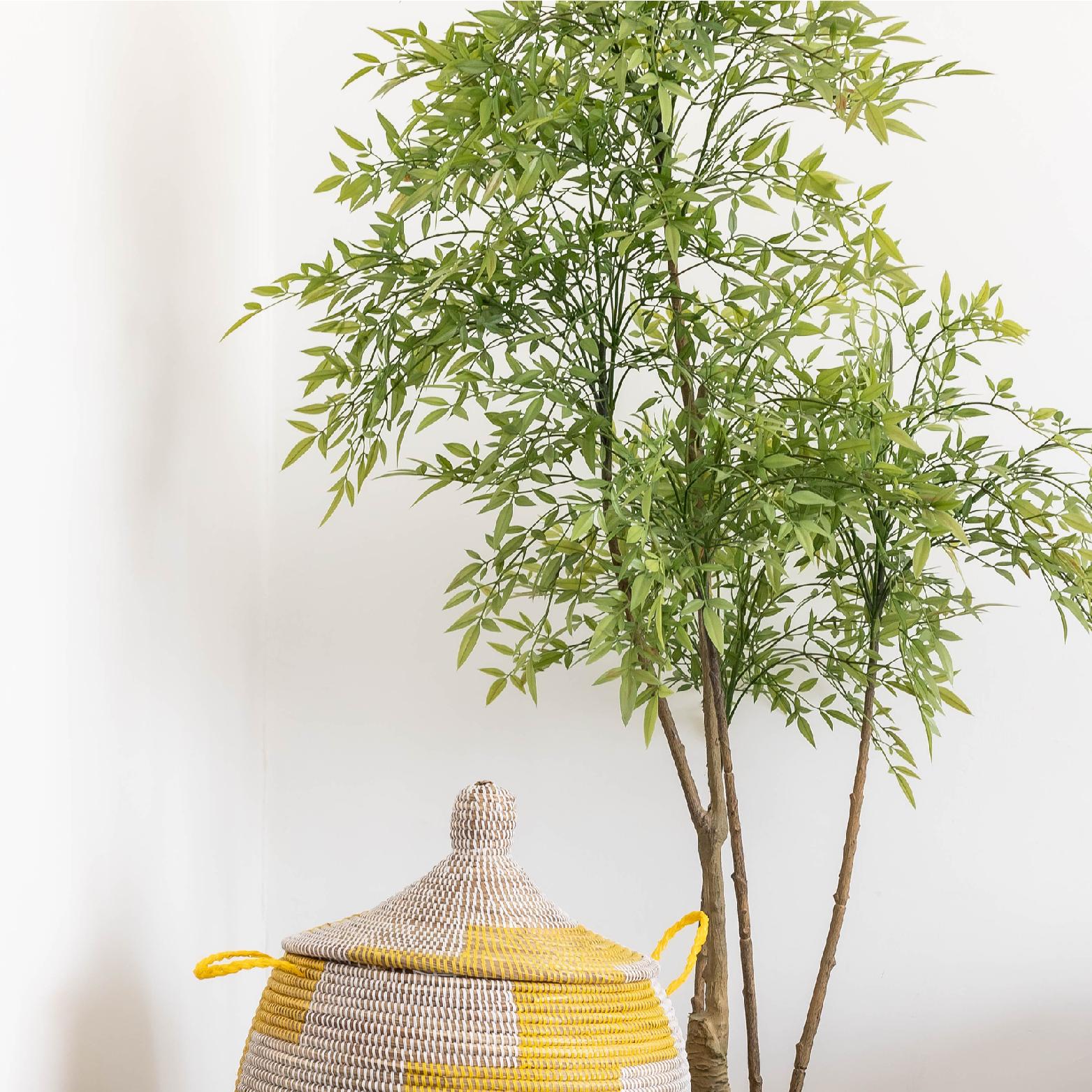 Artificial tree styled with a laundry basket 