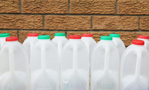 A row of washed and recyclable plastic cans