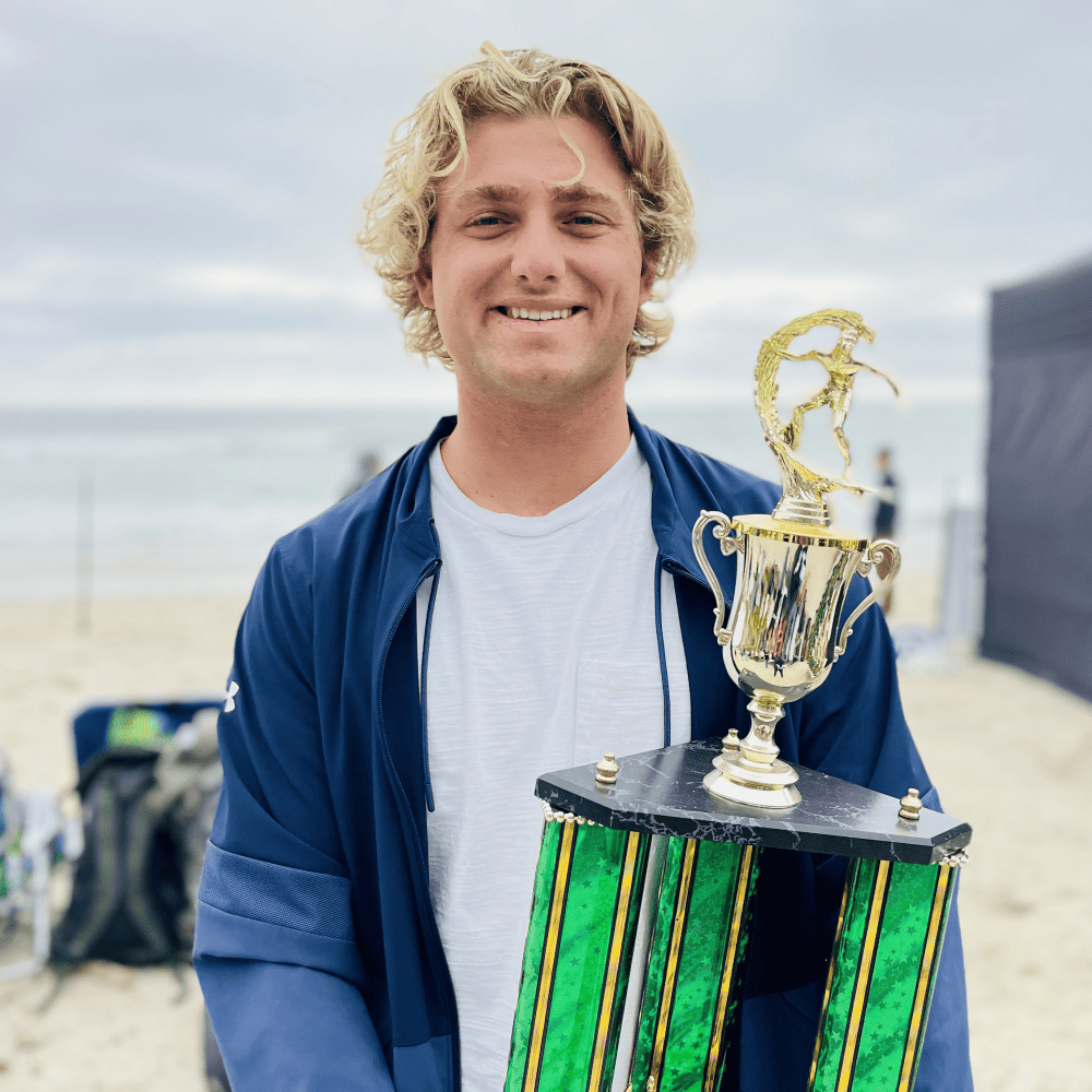 Jordy Collins holding a trophy from a competition