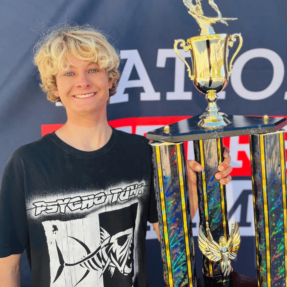 Sutton Tudor wearing Psycho Tuna graphic tee with trophy