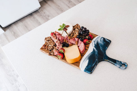 gluten free Charcuterie served on a blue and white epoxy resin cheese board