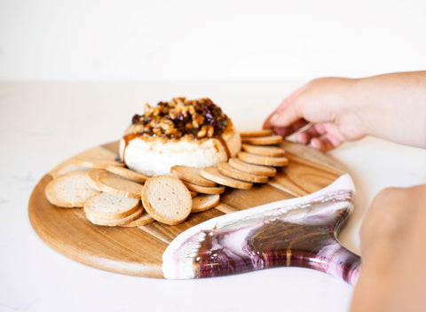 thanksgiving brie cheese and crackers on resin accented cheese board