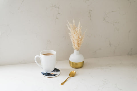 Ceramic resin coaster on kitchen counter with a coffee mug on top