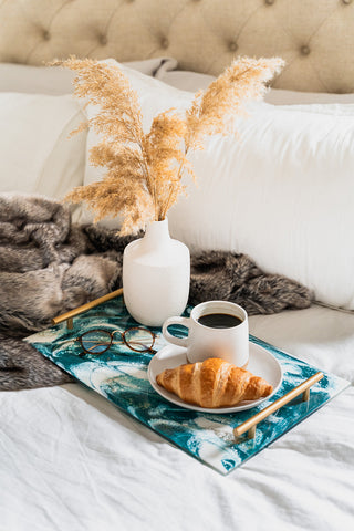 emerald jewel luctie tray serving coffee and crossaint in bed