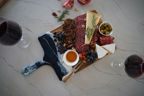 large resin accented cheese board served with classic charcuterie