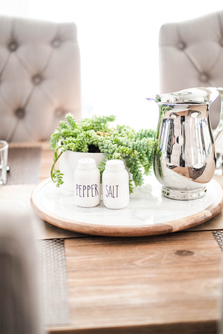 white and grey lazy susan displayed on a table along with salt and pepper shakers