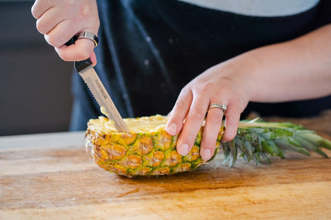 cutting a pineapple in half